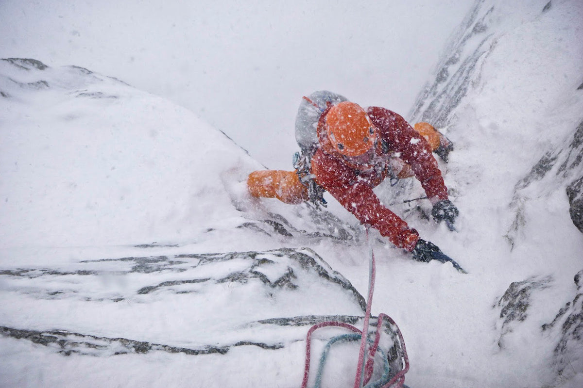 Climber ascending icy gully in Scottish Winter conditions