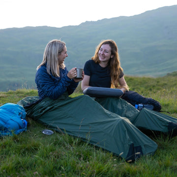 Wild camping under a lightweight tarp with a titanium cooking pot