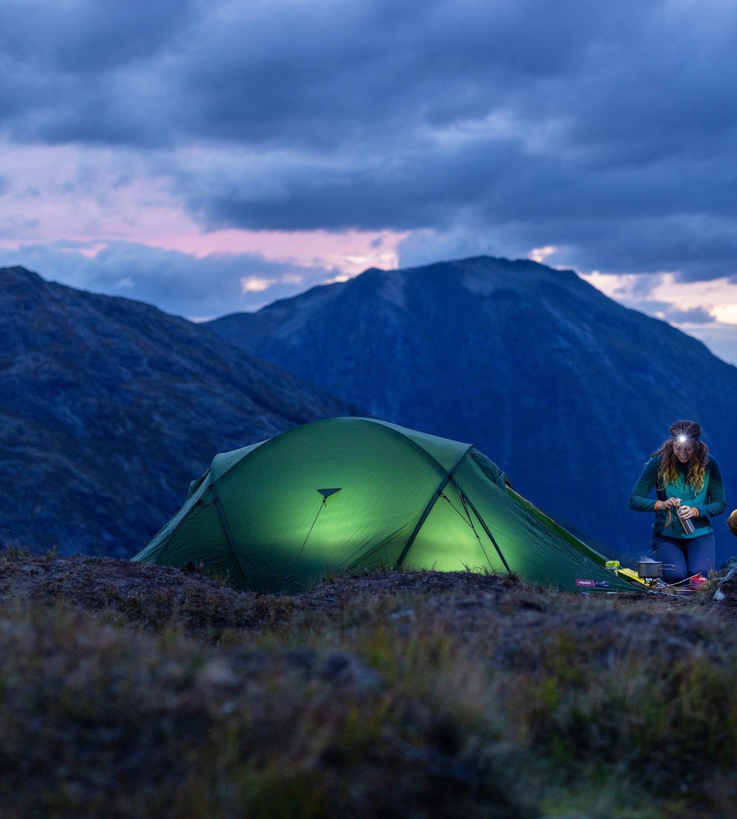 Wild camping with tent lit up in the night
