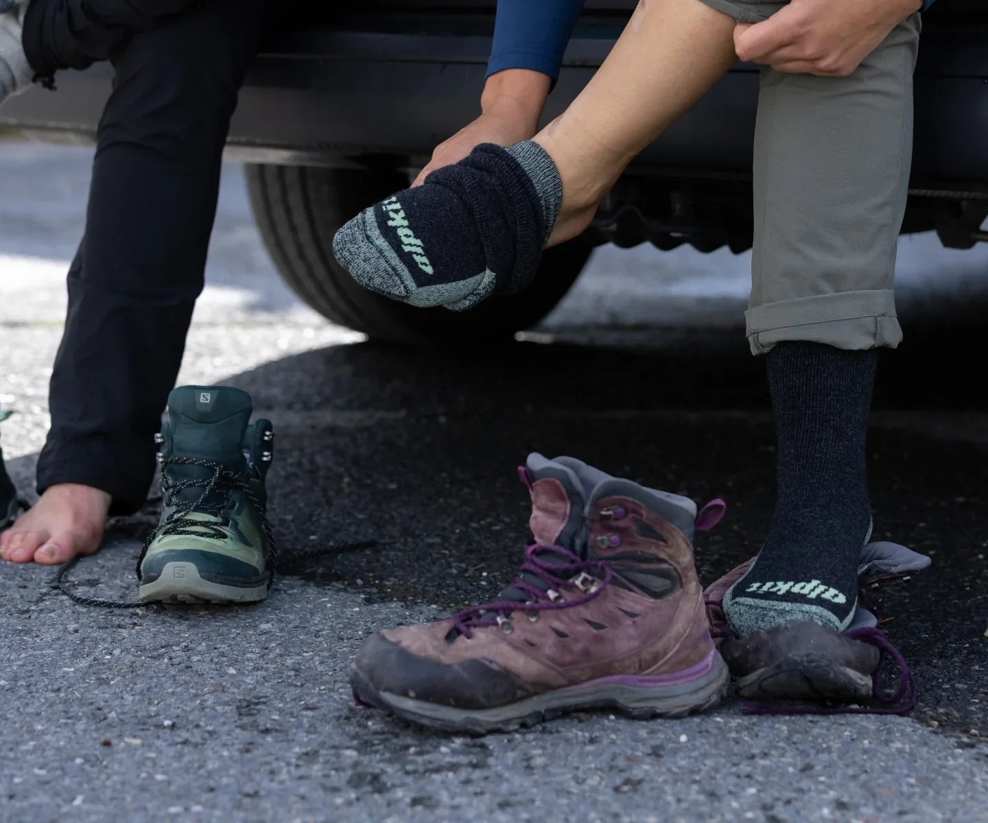 Hikers pulling on walking boots