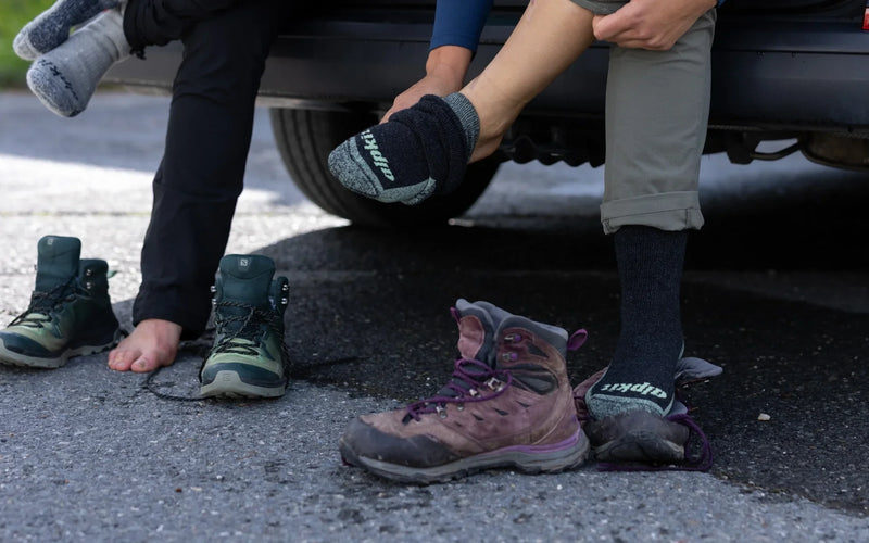 Hikers pulling on walking boots