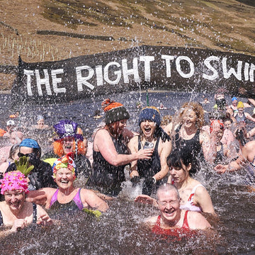 Two swimmers enter the water to go wild swimming