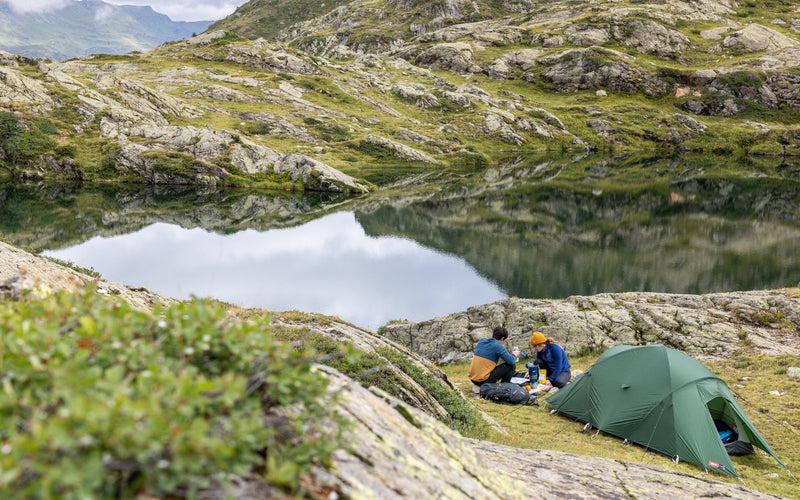 Wild camping by a lake in the mountains