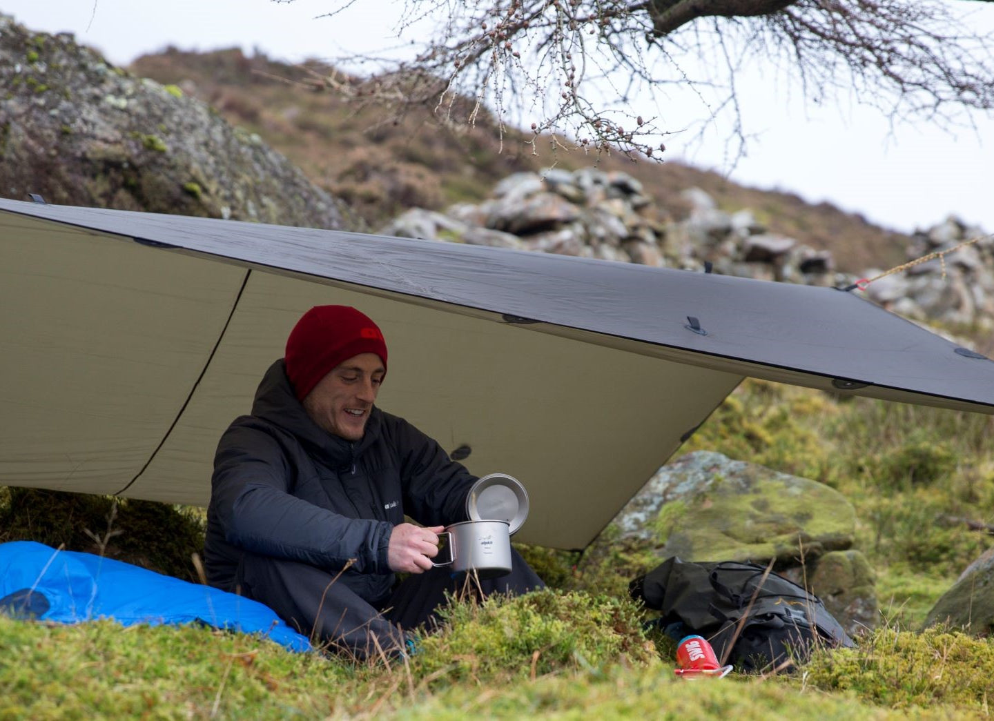 Wild camping under a lightweight tarp with a titanium cooking pot