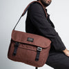 a man sitting on a stool with the bairn pro messenger in port colour