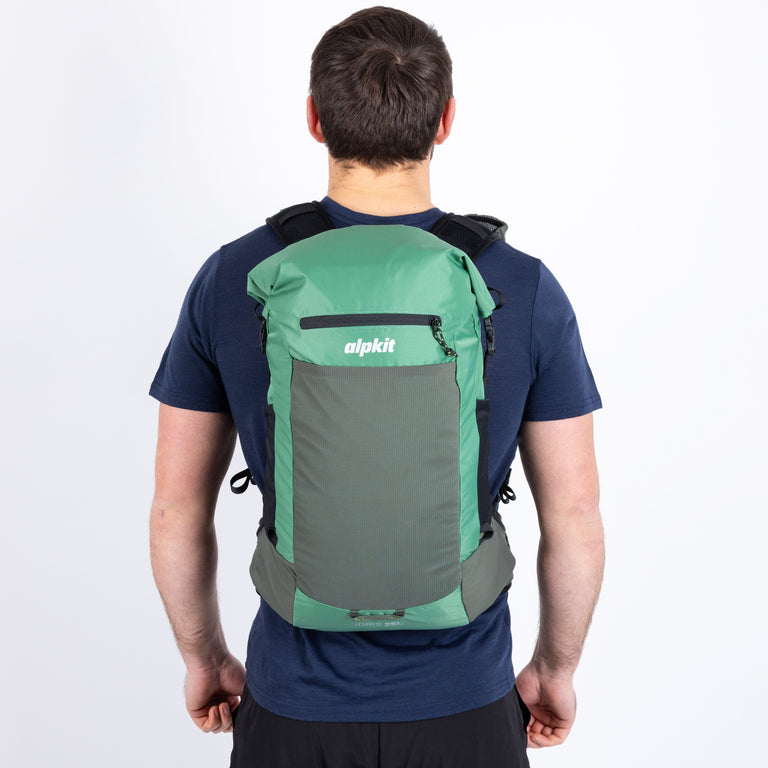 Person wearing a green and gray backpack