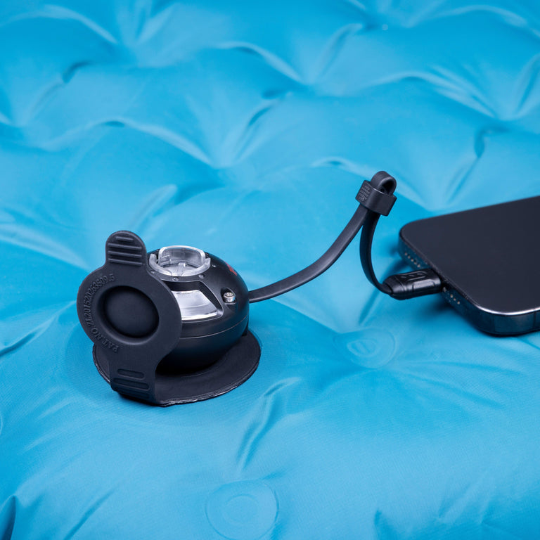 Micro Turbine Camping Mat Pump close up in use, powered by a mobile phone- closed