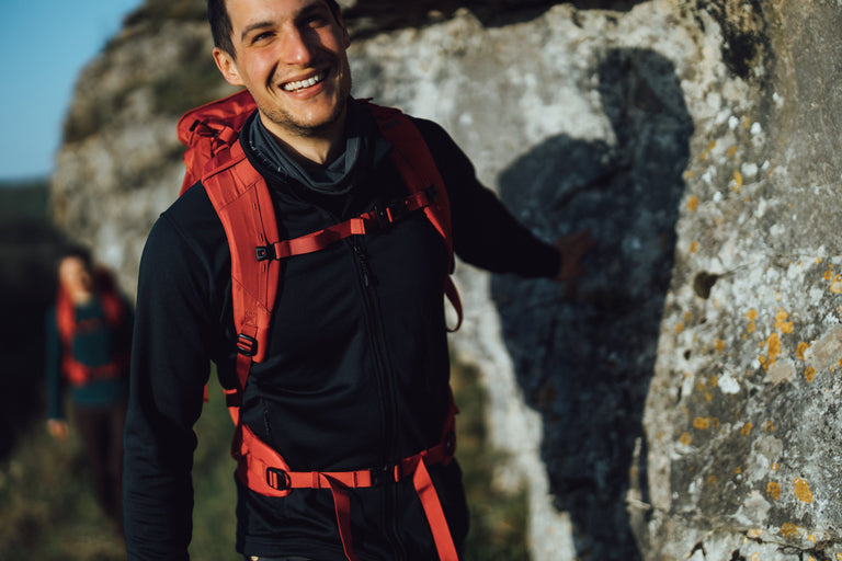 A man hiking in the Peak District in a black fleece jacket - action|sl